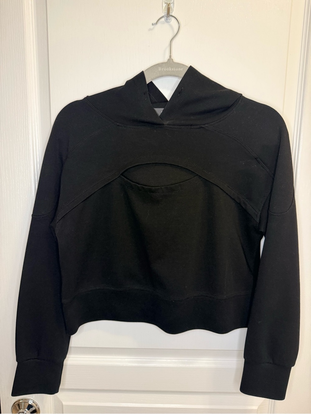 Black hooded cropped sweatshirt with front cutout. Size small.